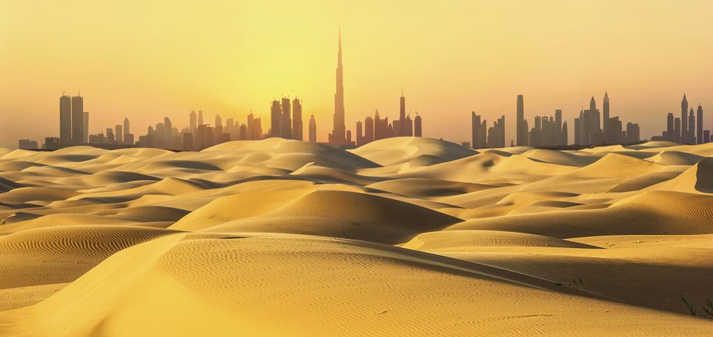 Dubai,Skyline,In,Desert,At,Sunset.